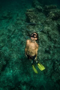 shirtless boy swimming underwater in ocean 2023 11 27 05 09 26 utc 1.webp